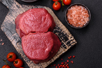 Fresh juicy raw beef medallions with salt and spices
