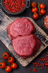 Fresh juicy raw beef medallions with salt and spices