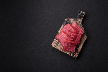 Juicy fresh raw beef meat with salt, spices and herbs