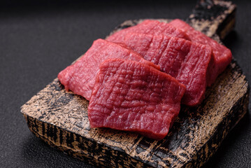 Juicy fresh raw beef meat with salt, spices and herbs