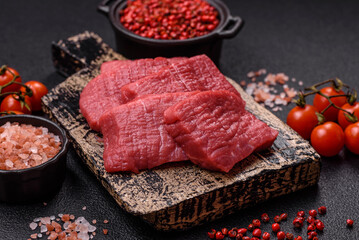 Juicy fresh raw beef meat with salt, spices and herbs