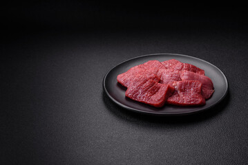 Juicy fresh raw beef meat with salt, spices and herbs