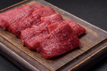 Juicy fresh raw beef meat with salt, spices and herbs