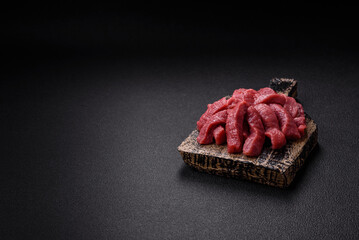 Juicy fresh raw beef meat with salt, spices and herbs