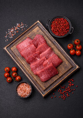 Juicy fresh raw beef meat with salt, spices and herbs