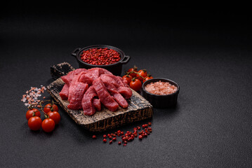 Juicy fresh raw beef meat with salt, spices and herbs