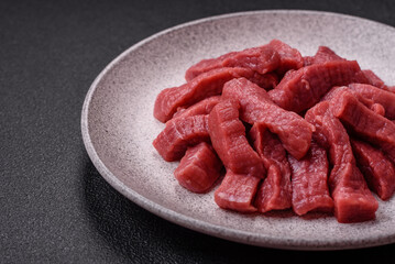 Juicy fresh raw beef meat with salt, spices and herbs