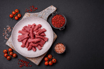 Juicy fresh raw beef meat with salt, spices and herbs