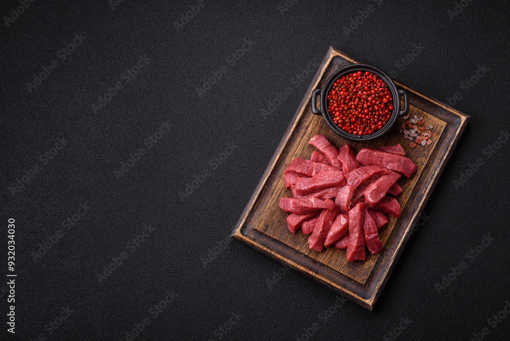 Wall mural Juicy fresh raw beef meat with salt, spices and herbs