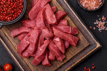 Juicy fresh raw beef meat with salt, spices and herbs