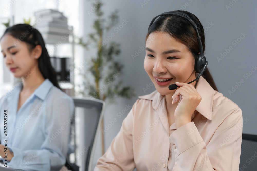 Poster customer service agent is smiling while talking to a customer on a headset in a busy office