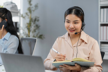 Customer service agent is taking notes while talking with a customer on a headset