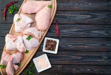 Raw mixed chicken meat parts  for cooking on rustic background