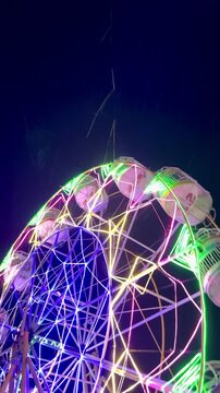 Cinematic Shoot Of ferris wheel or "Bianglala" at night markets in Bireuen, Indonesia as a game for residents and children