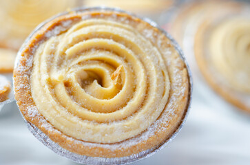 A pastry with a swirl of frosting on top