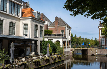 Typical Dutch cityscape on the sunny day with streets, a calm canal, parks, houses. The Hague, Netherlands