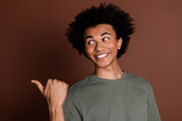 Photo of young positive guy with chevelure introduce his parents business new barber shop isolated on brown color background