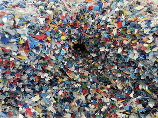Obraz premium Closeup image of colorful plastic flakes. Concept pollution, environment, save the planet. PP plastic recycling from bottles. Bottle cap. PET bottle recycled. High quality photo