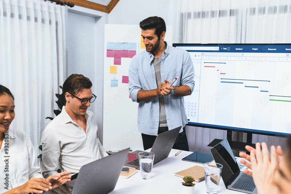 Leinwandbilder Project manager communicate and collaborate with team using project management software display on monitor, tracking progress of project task and making schedule plan at meeting table. Prudent