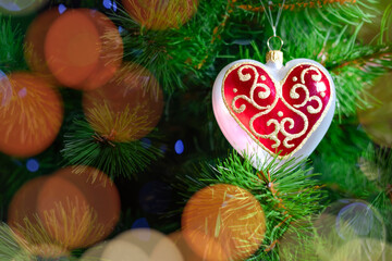 A Beautiful Heart Ornament Hanging on a Beautiful Christmas Tree, Bringing Joy and Color