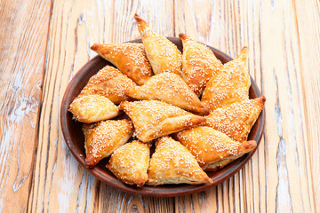 Homemade triangle puff pastry with meat on rustic background . Samosa