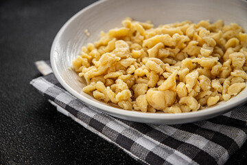 spaetzle egg pasta irregular shape fresh meal food snack on the table copy space food background rustic top view