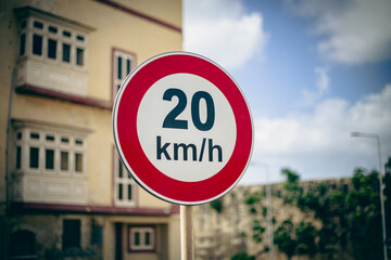 Obraz premium Twenty kilometres speed limit signal in a urban scene 