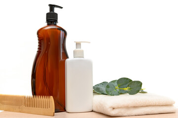 Brown bottle with dispenser. White plastic bottle with dispenser. Cosmetics in the bathroom.