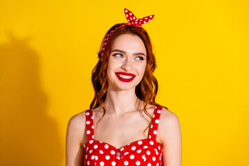 Photo of charming pretty lady wear red dress look empty space isolated on vivid yellow background