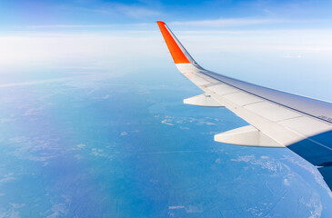 Aerial view from airplane window above green ground. View from the airplane window with beautiful...