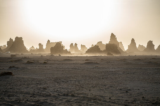 Moon landscape of limestone chimneys geological rock formations in a sunset rays at the bottom of dried salt lake Abbe, Djibouti