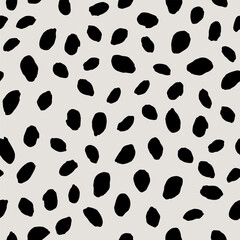 Abstract irregular black polka dot seamless pattern. Hand drawn artistic doodle sketch dots surface design
