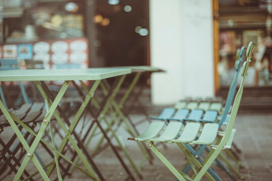 Close-up of cafe chairs and tables in a city street, Brussels, Belgium