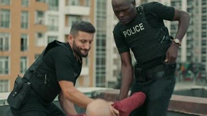 Policemen Arresting a bald criminal in the city