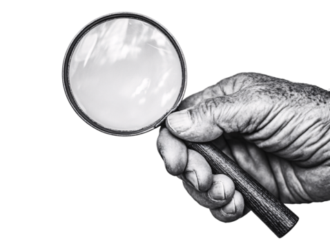 a hand holding a magnifying glass