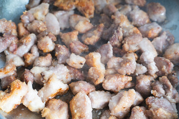 Pieces of pork are fried in a pan. Recipe.