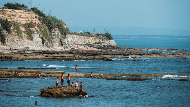 People relax at Avencas beach in Sao Pedro do Estoril near Lisbon, Portugal