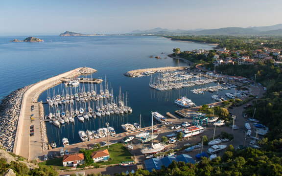 View over the marina and coastline to distant Arbatax and Capo Bellavista, Santa Maria Navarrese, Baunei, Nuoro, Sardinia, Italy, Mediterranean