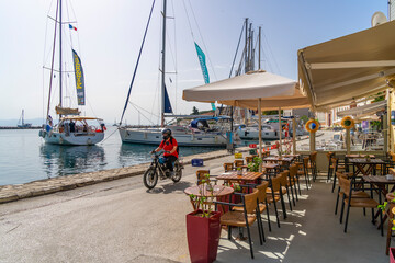 View of boats and cafes in the harbour in Gaios Town, Paxos, Ionian Sea, Greek Islands, Greece