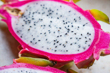 Pitaya or dragon fruit, cut on a marble surface