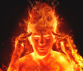 Conceptual man on fire with his eyes closed and hands on his temples