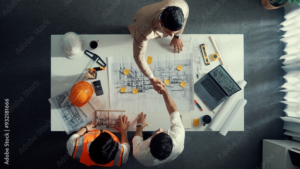 Poster top down aerial view of architect engineer team shake hands and discussing about building constructi