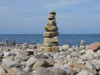 Stacked stones to form towers and figures on the beach are popular photo motifs that tourists pile...