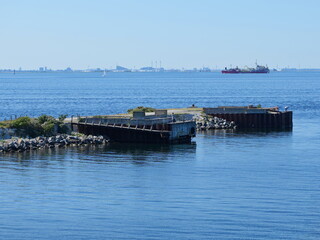 The remnants of the old pier at the Öresund Bridge reveal historical architecture in fragments,...