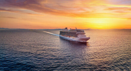 Aerial summer sunset view of a generic cruise ship traveling over the calm ocean as a concept for...