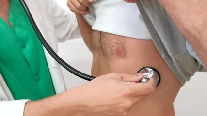 4K video of male doctor check-up with stethoscope a male patient in his 30s. He use a medical equipment to monitor heart and lung function during a medical consultation in public hospital - Powered by Adobe