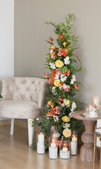 Wedding dais. Wedding ceremony area. Yellow and orange color flowers are decorated with a seat