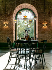 Stylish restaurant interior with vintage decor and natural light, creating a unique space