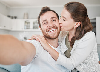 Couple, kiss and portrait in home for selfie, photography and document memories for future in lounge. House, woman and man with affection for bonding, connection and profile picture for social media