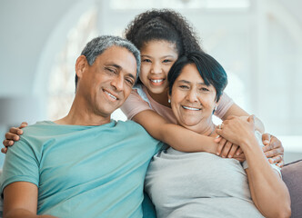 Obraz premium Grandparents, child and hug in portrait on couch with happiness, love and support in home. Family, care and smile together in living room, apartment or relax on sofa in house with senior couple